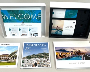 An Inspirato welcome kit is unpacked to show a variety of printed materials.