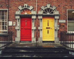 Two doors, one red and one yellow, stand side by side.